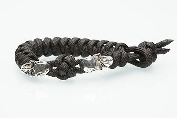 Image showing Black braided bracelet with skulls on white background