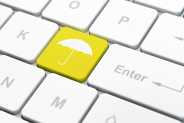 Image showing Safety concept: Umbrella on computer keyboard background