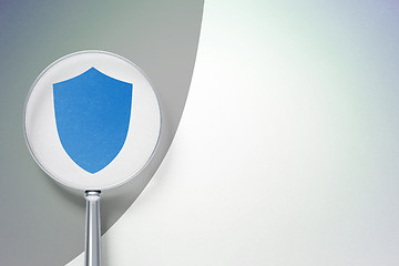 Image showing Protection concept:  Shield with optical glass on digital background