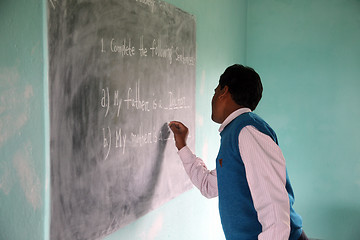 Image showing Teacher writes on blackboard at school, Kumrokhali, West Bengal, India