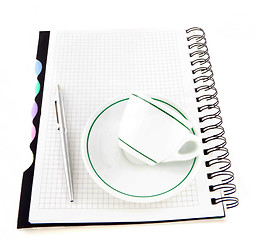 Image showing Coffee and pen on notebook isolated