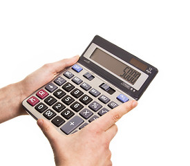 Image showing Male businessman using a calculator