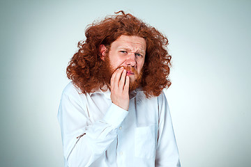 Image showing Young man is having toothache.