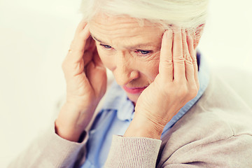 Image showing face of senior woman suffering from headache