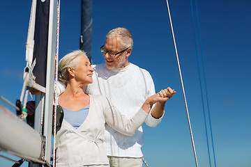 Image showing happy senior couple on sail boat or yacht in sea