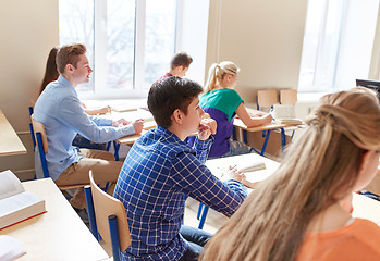 Image showing group of students with notebooks at school lesson