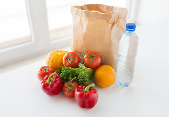 Image showing basket of fresh vegetables and water at kitchen