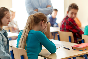 Image showing crying student girl with test result and teacher