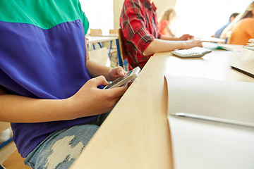 Image showing student girl with smartphone texting at school