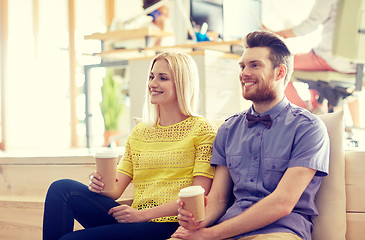 Image showing happy man and woman drinking coffee in office