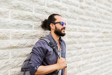 Image showing man with backpack standing at city street wall