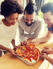 Image showing happy business team eating pizza in office