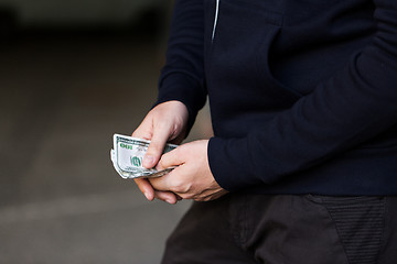 Image showing close up of addict or drug dealer hands with money