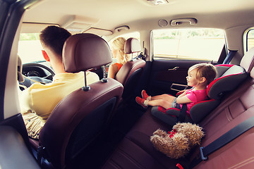 Image showing happy parents with little child driving in car