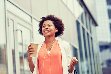 Image showing happy african businesswoman with coffee in city