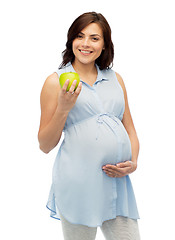 Image showing happy pregnant woman holding green apple