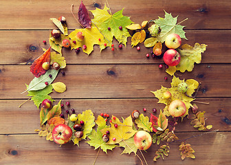 Image showing set of autumn leaves, fruits and berries on wood