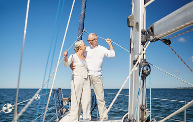 Image showing senior couple hugging on sail boat or yacht in sea