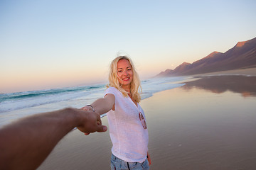 Image showing Romantic couple holding hands on beach.