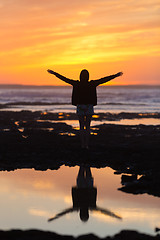 Image showing Free woman enjoying freedom on beach at sunset.