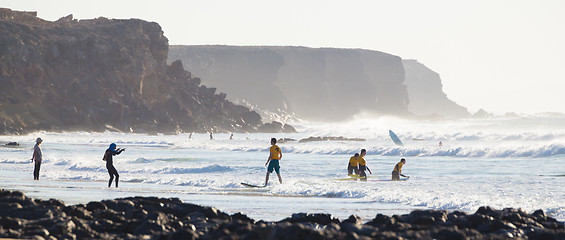 Image showing Surfers surfing on El Cotillo beach, Fuerteventura, Canary Islands, Spain.