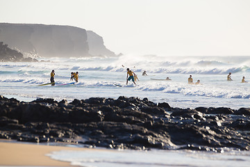 Image showing Surfers surfing on El Cotillo beach, Fuerteventura, Canary Islands, Spain.