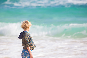 Image showing Boy playing with toys on beach.