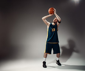 Image showing Full length portrait of a basketball player with ball