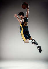 Image showing Full length portrait of a basketball player with ball