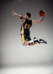 Image showing Full length portrait of a basketball player with ball