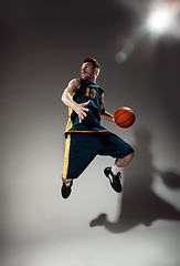 Image showing Full length portrait of a basketball player with ball