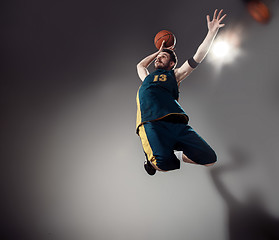 Image showing Full length portrait of a basketball player with ball