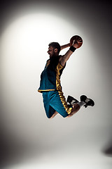 Image showing Full length portrait of a basketball player with ball