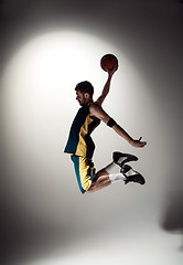 Image showing Full length portrait of a basketball player with ball