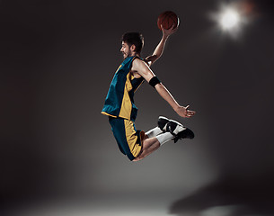 Image showing Full length portrait of a basketball player with ball