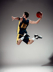 Image showing Full length portrait of a basketball player with ball