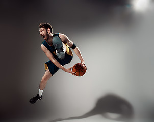 Image showing Full length portrait of a basketball player with ball