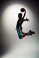 Image showing Full length portrait of a basketball player with ball