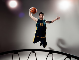 Image showing Full length portrait of a basketball player with ball