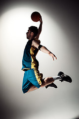 Image showing Full length portrait of a basketball player with ball