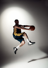 Image showing Full length portrait of a basketball player with ball