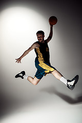 Image showing Full length portrait of a basketball player with ball