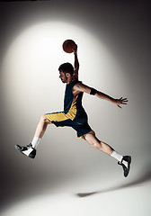 Image showing Full length portrait of a basketball player with ball