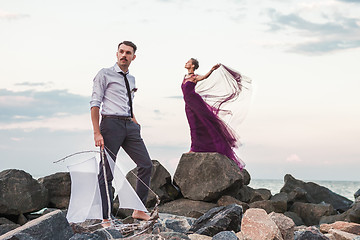 Image showing Young romantic couple relaxing on the beach watching the sunset