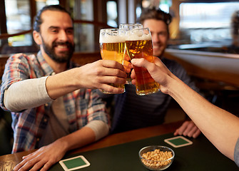 Image showing happy male friends drinking beer at bar or pub