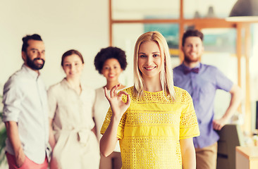 Image showing happy woman showing ok over creative office team