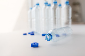 Image showing close up of empty water bottles and caps on table