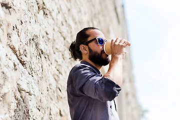 Image showing man drinking coffee from paper cup on street