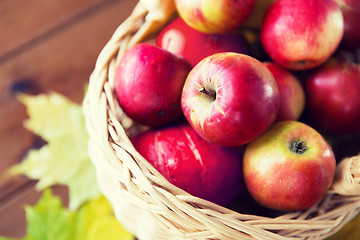 Image showing close up of basket with apples on wooden table