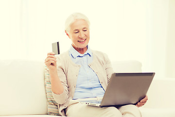 Image showing senior woman with laptop and credit card at home